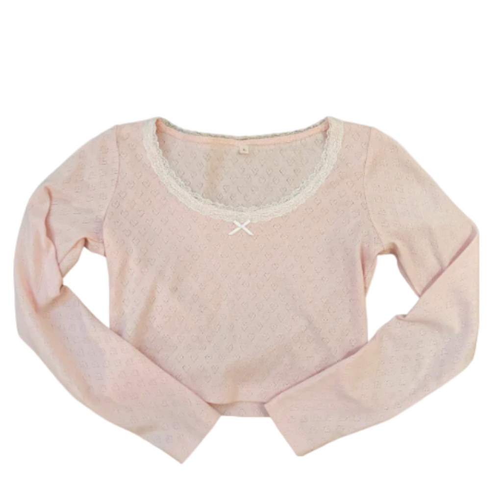 Light pink long-sleeve crop top on a white background